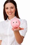 Confident businesswoman showing a piggybank 