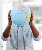 Afro-american businessman holding a terrestrial globe