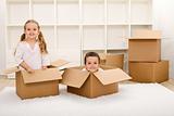 Kids in their new home with boxes