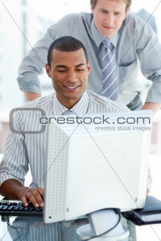 Afro-american businessman working at a computer 