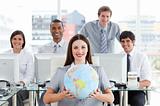 Pretty businesswoman and her team showing a terrestrial globe