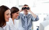 Charismatic manager looking through binoculars