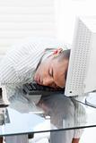 Businessman sleeping on a keyboard