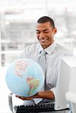 Smiling businessman holding aterrestrial globe