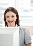 Smiling businesswoman working at a computer