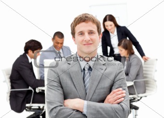 Caucasian businessman sitting in front of his team 
