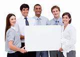Smiling international business people holding a white card 