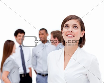 Young businesswoman looking up in front of her colleagues