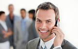 Focus on a smiling businessman on phone 
