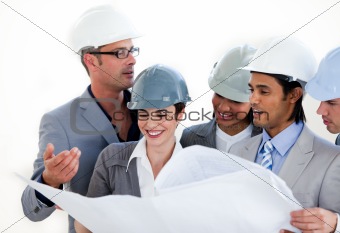 International engineers studying a construction plan 