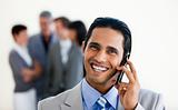 Focus on an assertive ethnic businessman on phone 