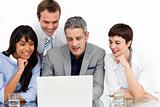 Multi-ethnic business team using a laptop