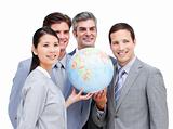 Portrait of a multi-ethnic businessteam holding a globe 