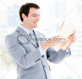 Portrait of a relaxed businessman reading a newspaper 