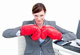 Confident businesswoman preparing to fight with boxing gloves 