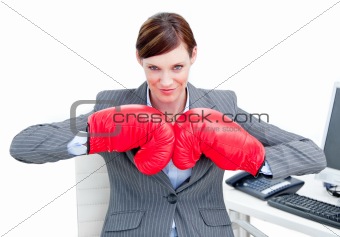 Confident businesswoman preparing to fight with boxing gloves 