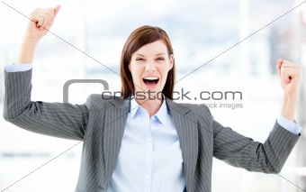 Positive businesswoman punching the air 