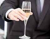 Close-up of a businessman celebrating an event with champagne