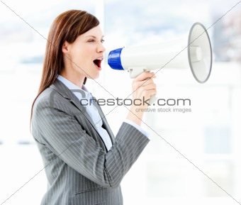 Portrait of an beautiful businesswoman using a megaphone 