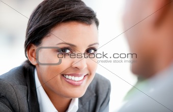 Portrait of a pretty businesswoman talking with her colleague 