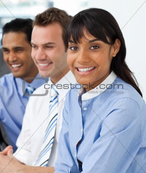 Multi-ethnic young business team sitting in a row