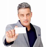Serious businessman holding a white card 