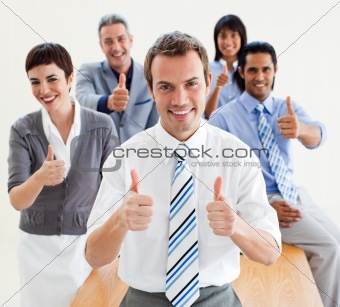 Fortunate business people with thumbs up