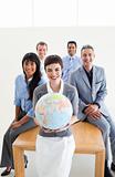 Multi-ethnic business people holding a terrestrial globe 