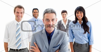 Business partners standing around a table 
