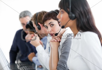 Charming businesswoman with headset on in a call center 