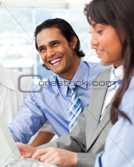 Laughing businessman working with his team