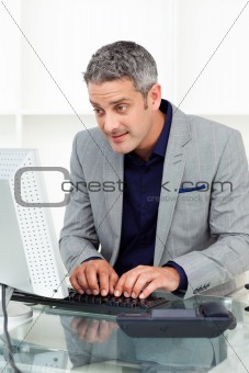 Concentrated businessman working at a computer 