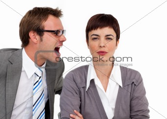 Angry businessman shouting into his colleague's ear 
