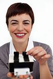 Positive businesswoman consulting a business card holder 