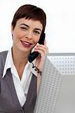 Assertive Businesswoman on phone at her desk 