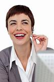 Laughing businesswoman with headset on 