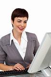 Self-assured businesswoman working at her computer 