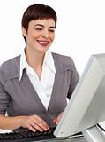 Positive female executive working at her computer 