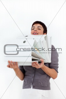 Attractive businesswoman carrying a stack of folders 