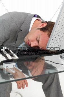 Tired businessman sleeping on his desk 