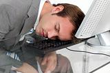 Close-ep of a tired businessman sleeping on his desk 