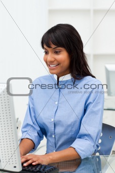 Smiling businesswoman working at a computer 