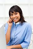 Delighted ethnic businesswoman on phone 