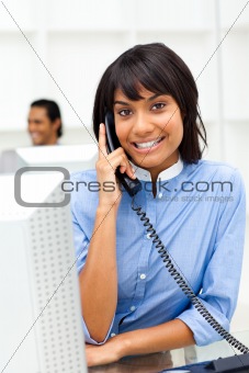 Positive ethnic businesswoman on phone 