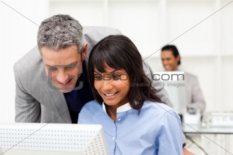 Manager checking his employee's work 