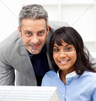 Confident business partners working at a computer in the office