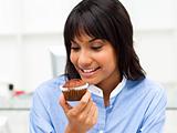 Close-up of a businesswoman eating a muffin 