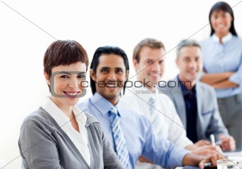 Smiling business co-workers sitting in a line 