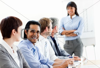 Charming businessman looking at the camera in a meeting 