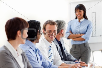 Confident businesswoman with folded arms doing a presentation 
